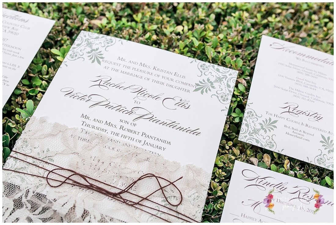  close up on invitations sitting on a hedge 