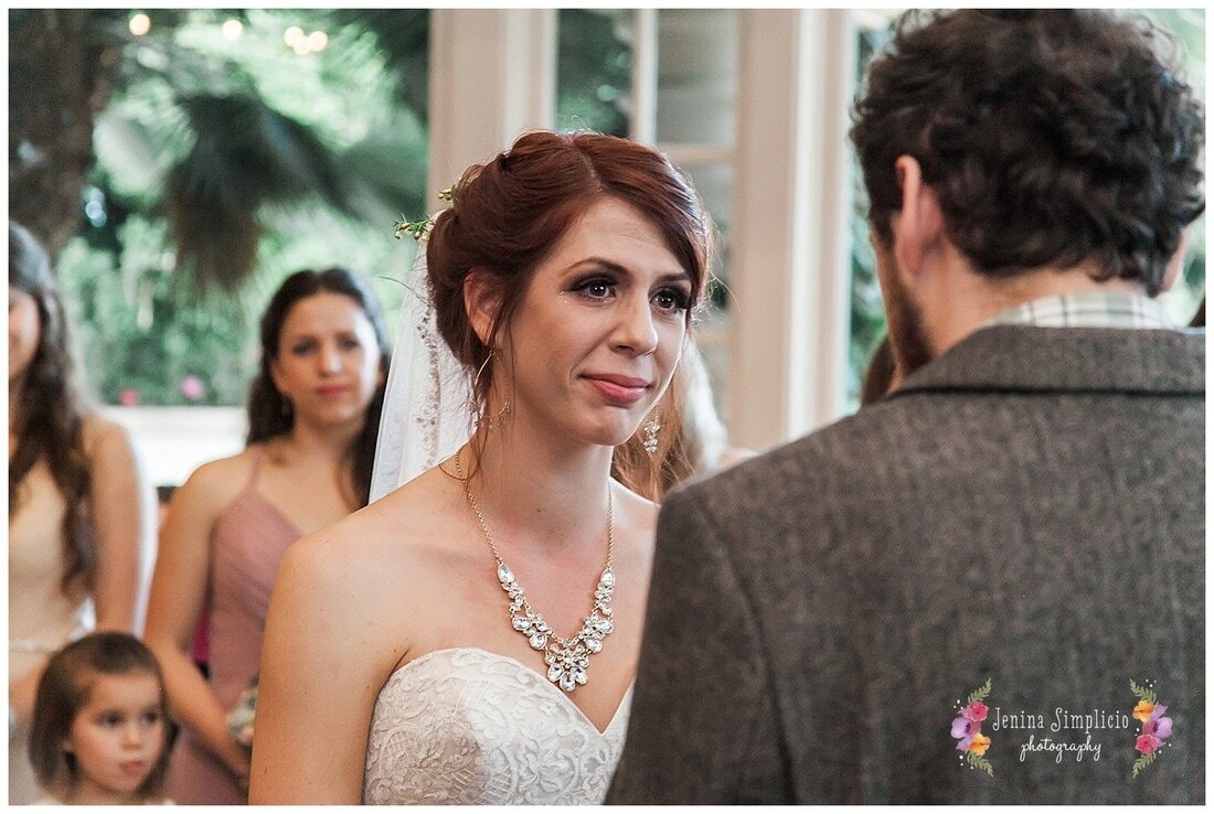  close up on bride’s face as her groom reads his vows 