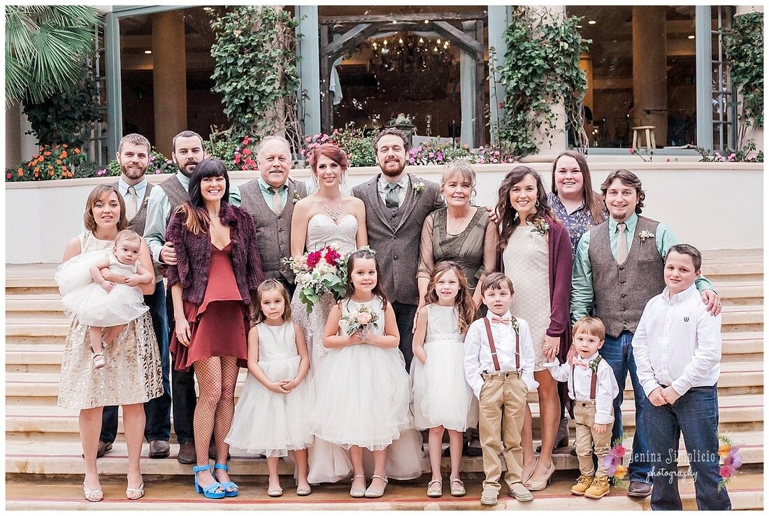  family photo with the bride and groom on the steps of the ceremony hall 