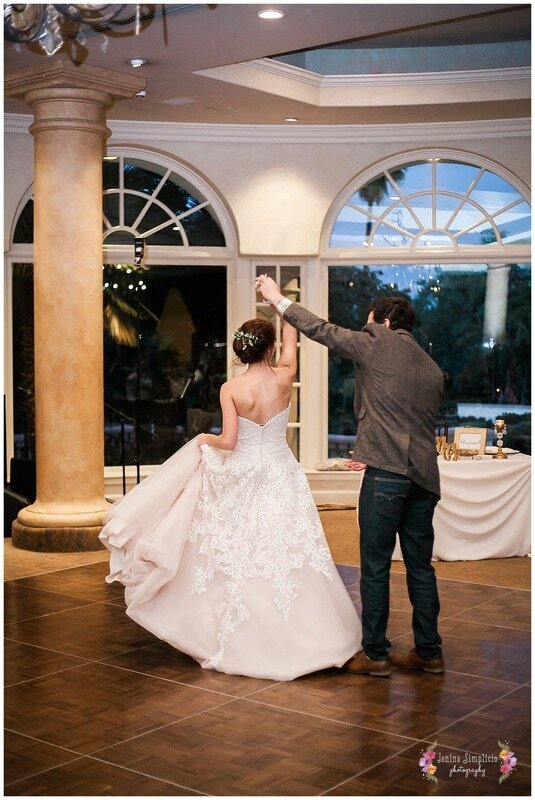  groom twirls bride on the dance floor 