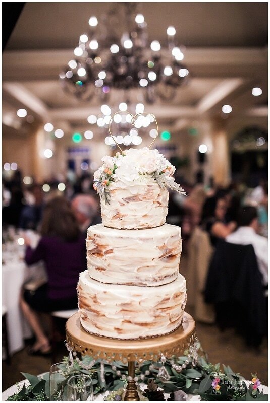  wedding cake topped with white flowers 