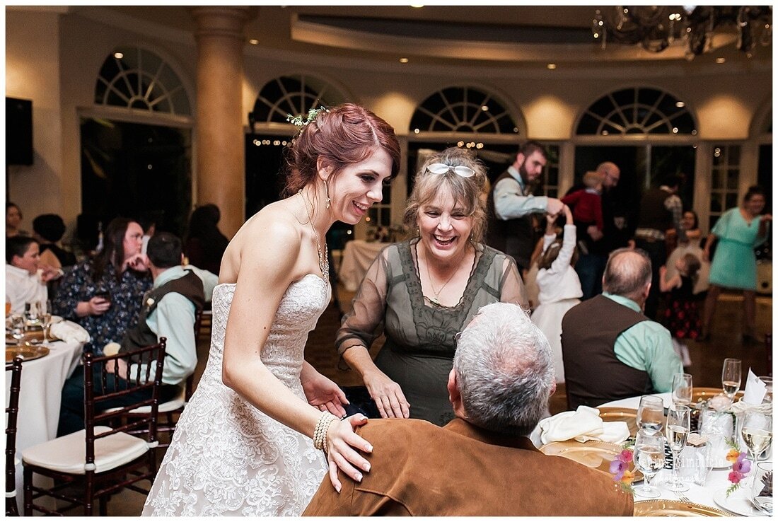  bride visits with guests during the reception 