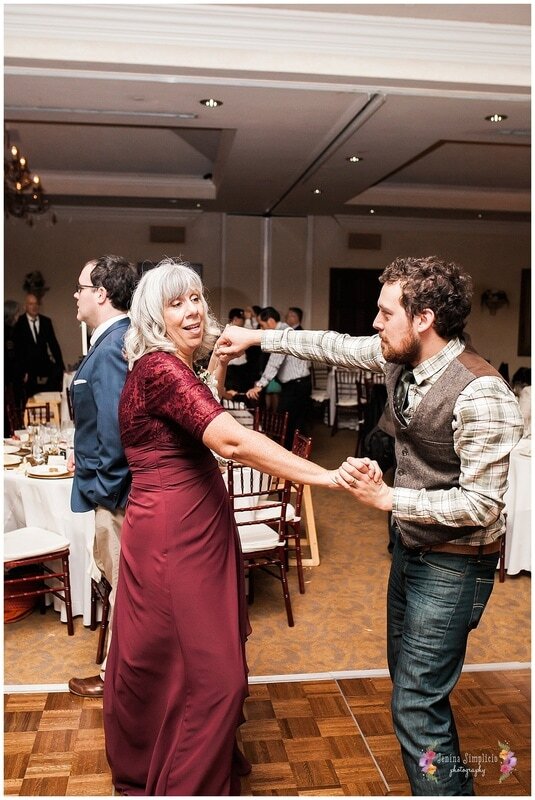  groom dancing with his mother in law on the dance floor 