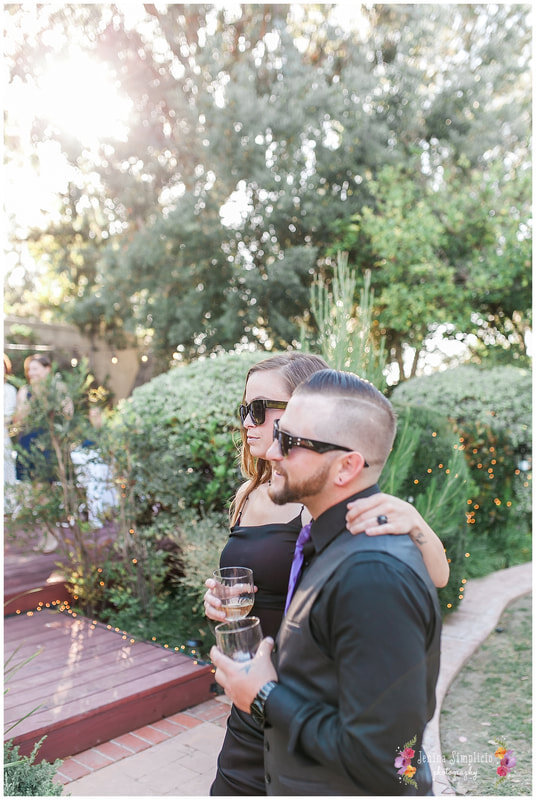  wedding guests enjoying beverages and sporting sunglasses 