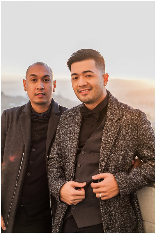  grooms to be standing together with the city skyline behind them 