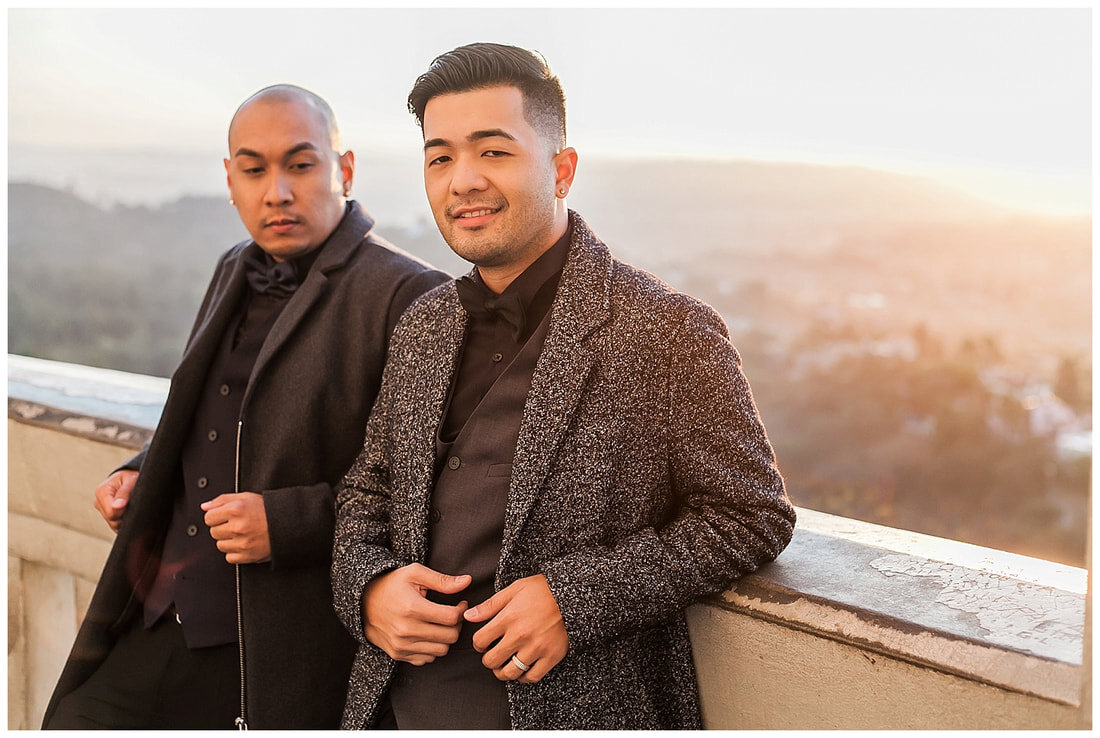  grooms to be standing together with the city skyline behind them 
