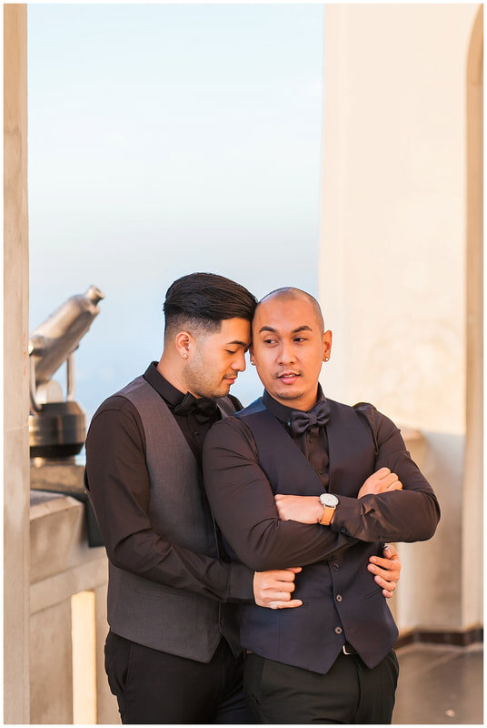  groom rests his forehead on his grooms head and wraps his arms around him 