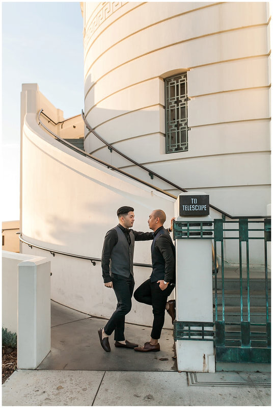  groom leans against the stairwell entrance and groom has hand next to his head 