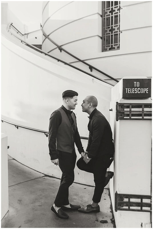  grooms about to kiss at the base of the observatory ramp 
