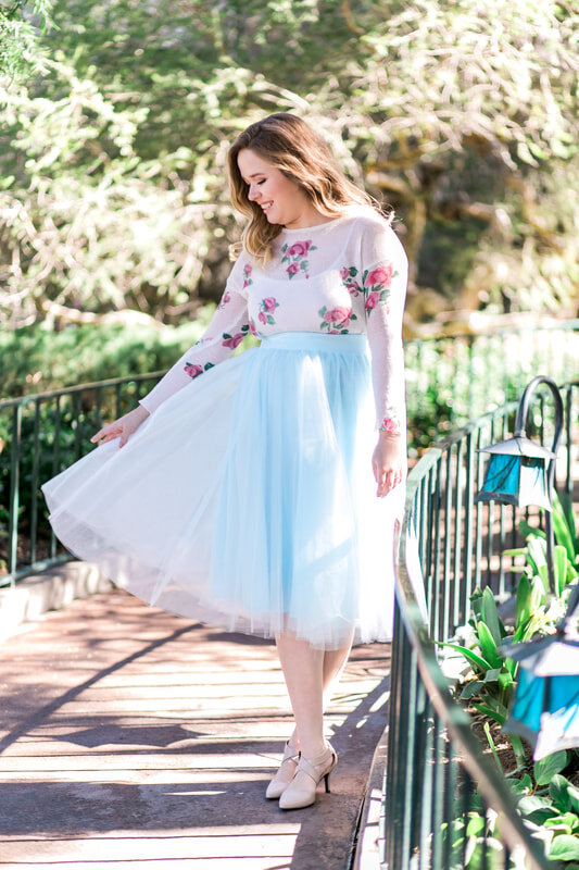  bride to be holding out her pale blue skirt 