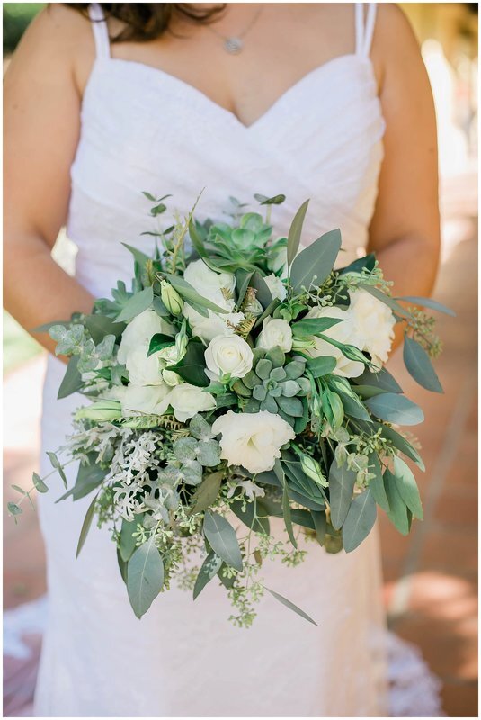  bride holding her bouquet of white flowers and succulents 