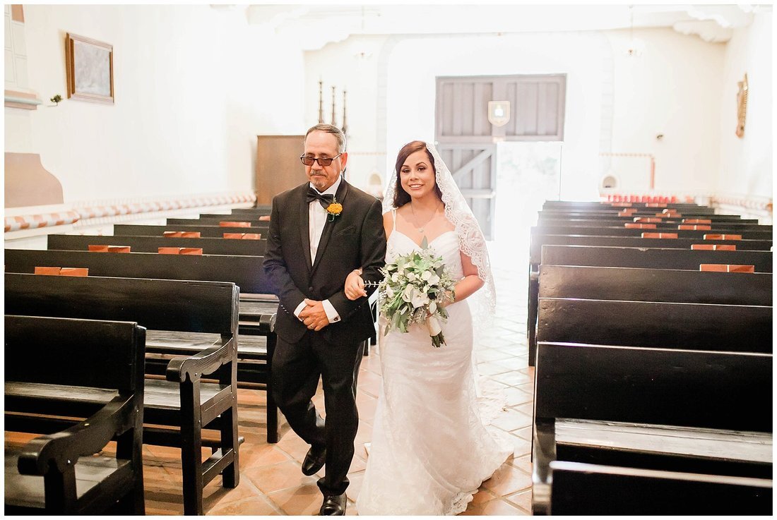  bride walks down the aisle with her father  