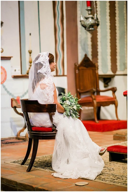  bride sitting at the altar holding a bouquet 