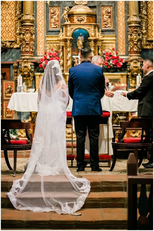  bride and groom stand at the altar of the church 