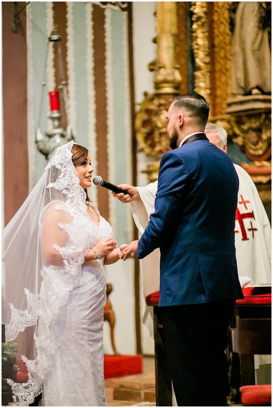  bride says her vows and puts a ring on her husbands finger 