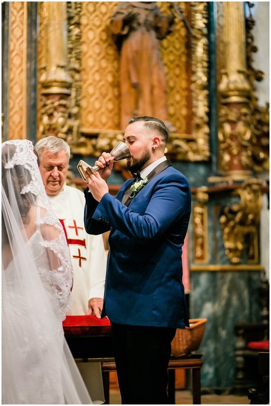  groom drinks from the chalice at the church altar 