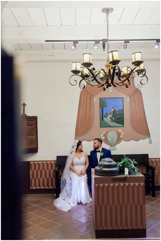  bride and groom sit together in the church pew 