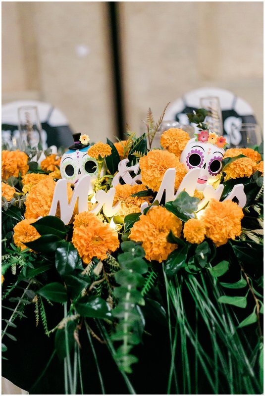  close up of mr and mrs day of the dead themed dinner table 
