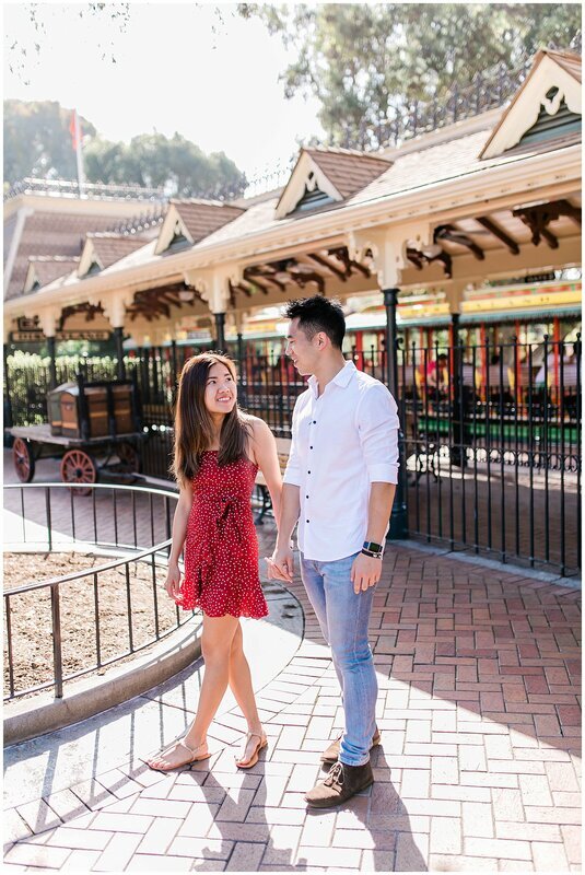  engaged couple in front of the disney trolley 