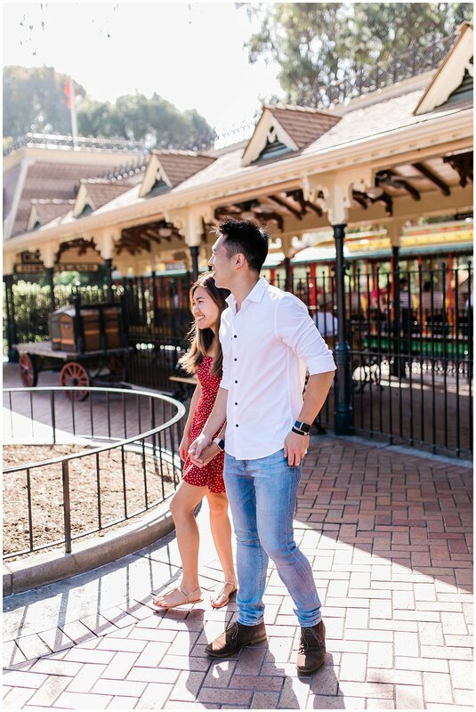  engaged couple in front of the disney trolley 