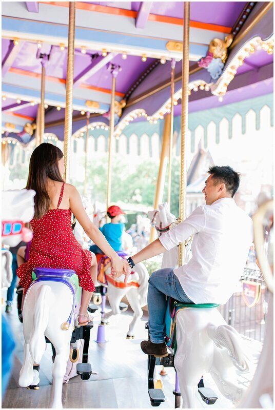  engaged couple on the disney carousel  