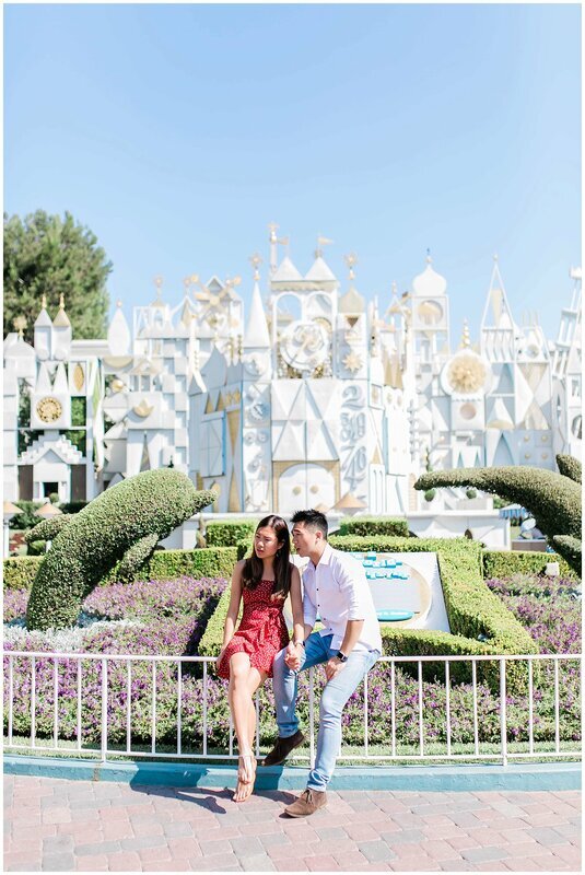  engaged couple in front of the magic kingdom 