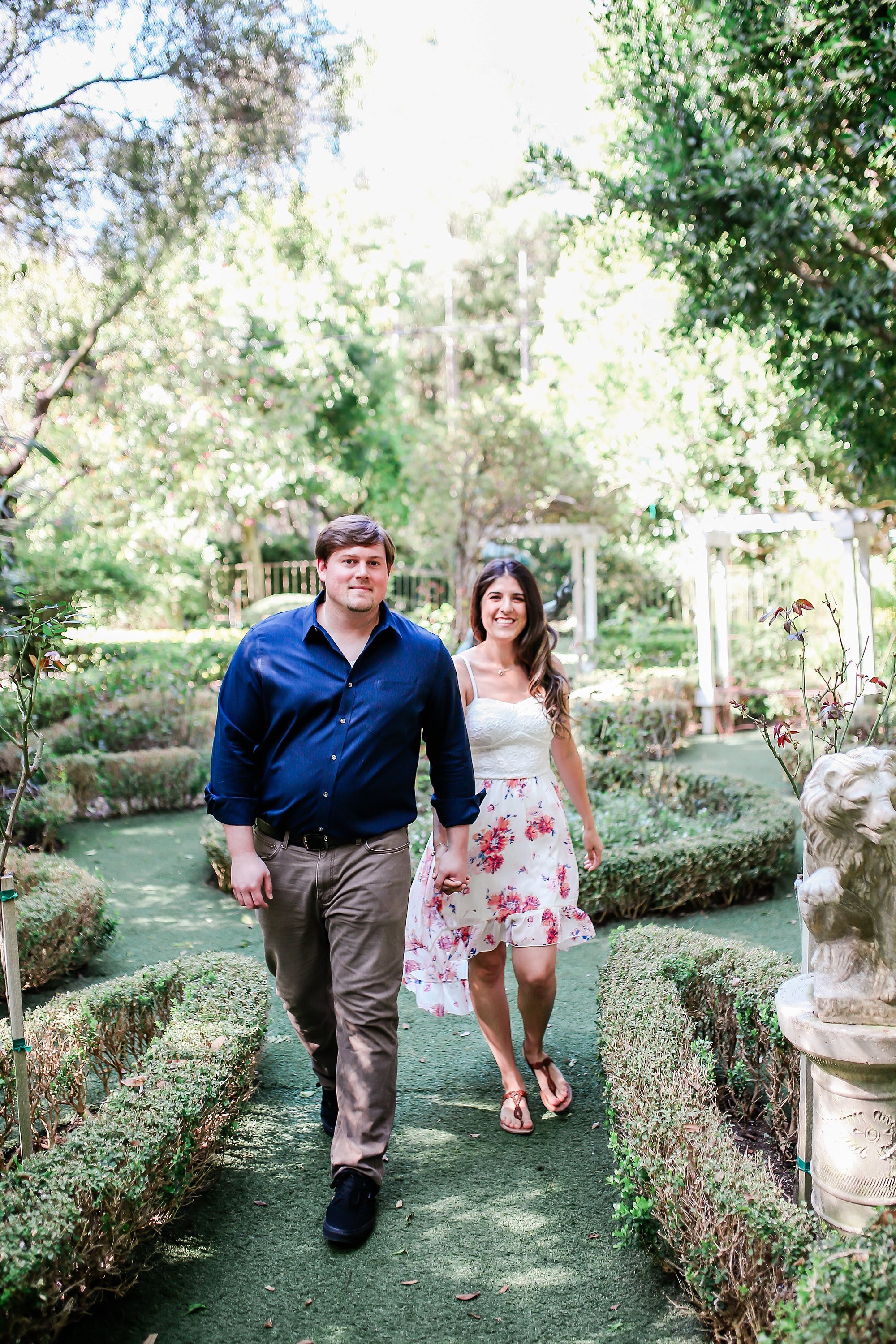  bride and groom walking in the botanical garden 