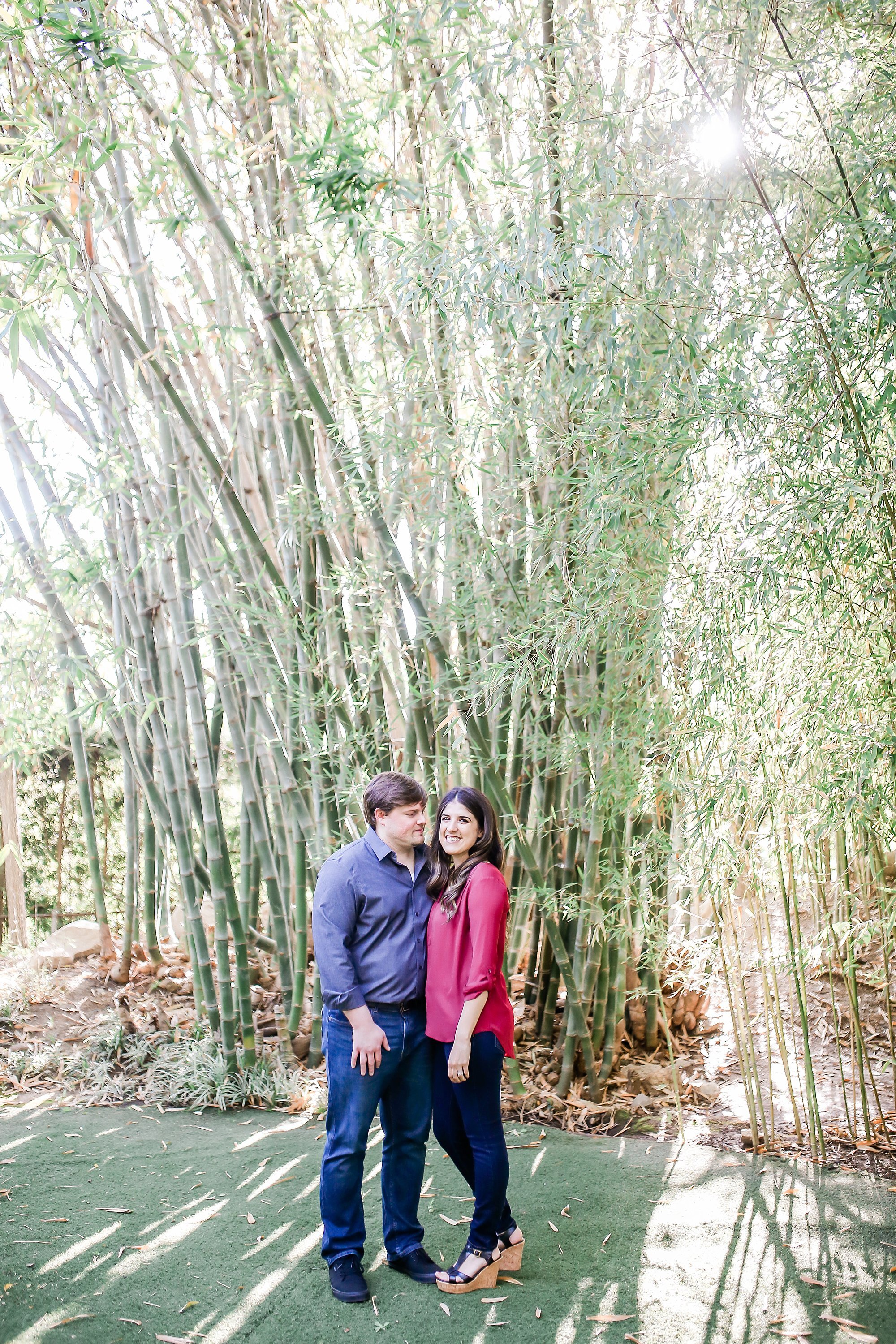  newly engaged couple embracing in the orchard 