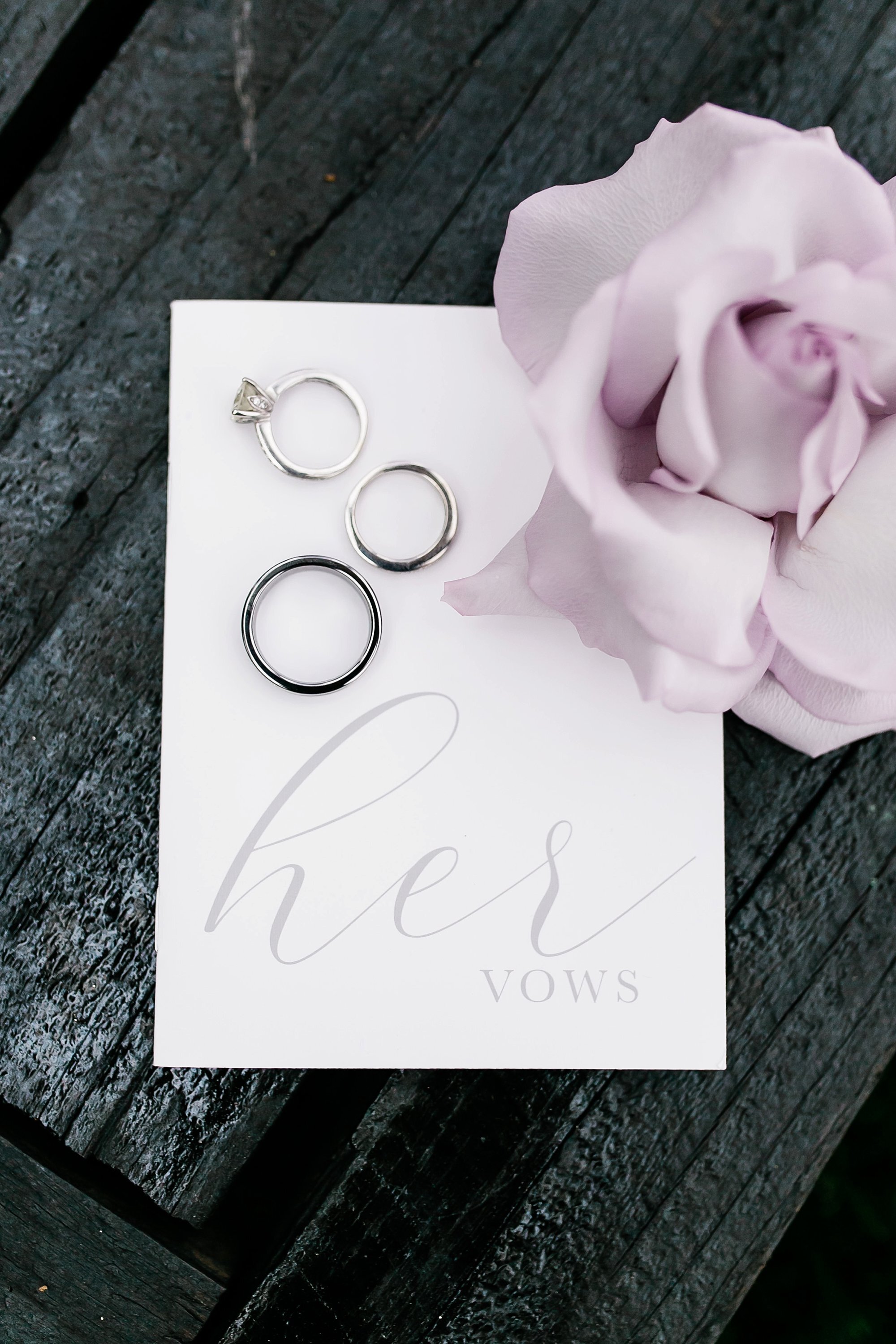  wedding bands on a card with a lilac flower 