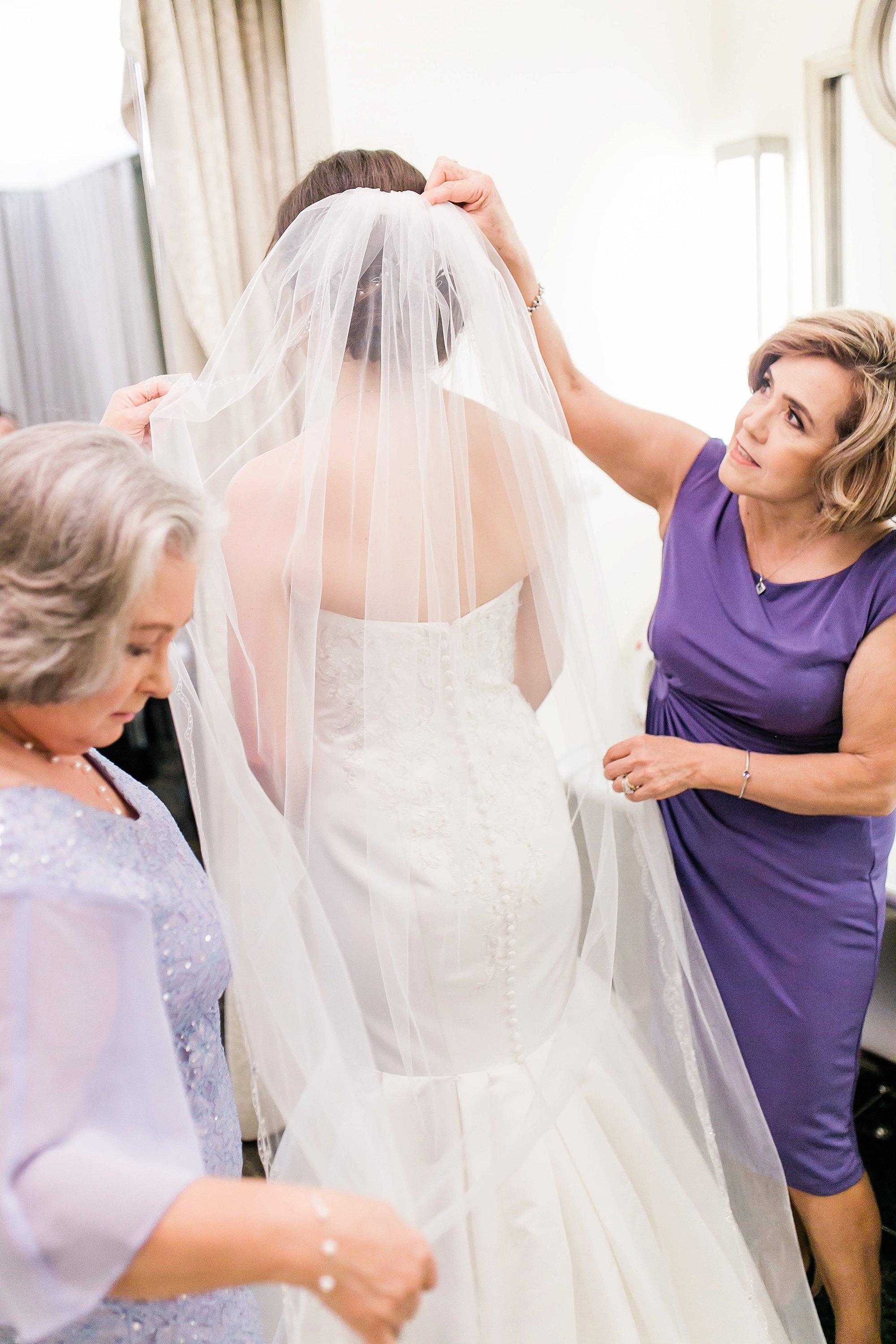  mother helping the bride get ready 