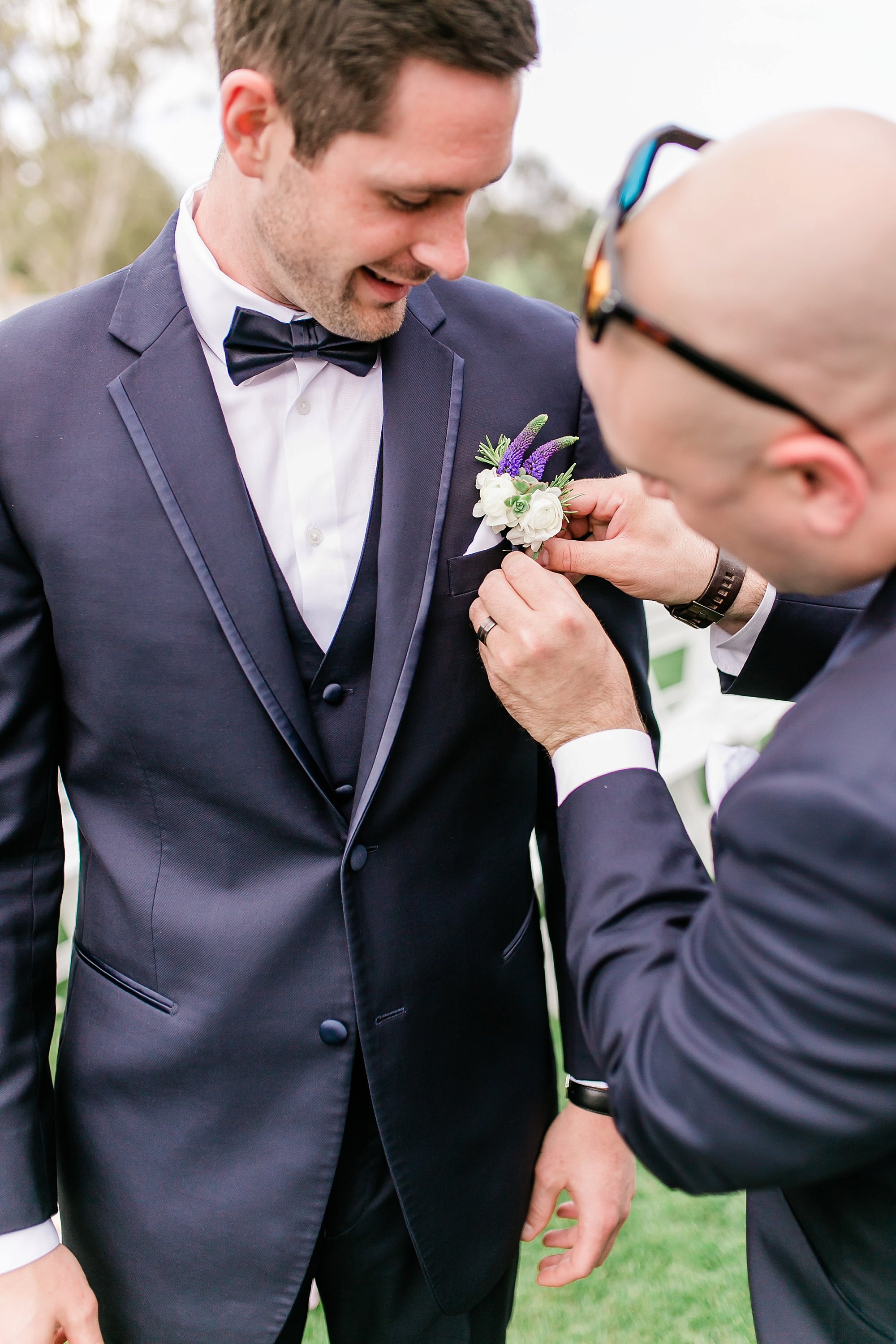  best man helping groom with boutonniere  