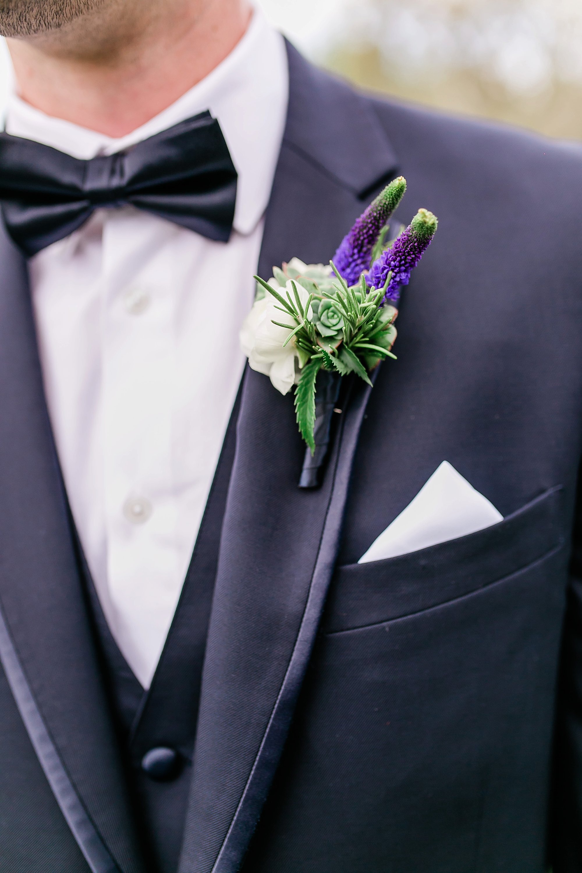  groom’s tux with flower and pocket square 