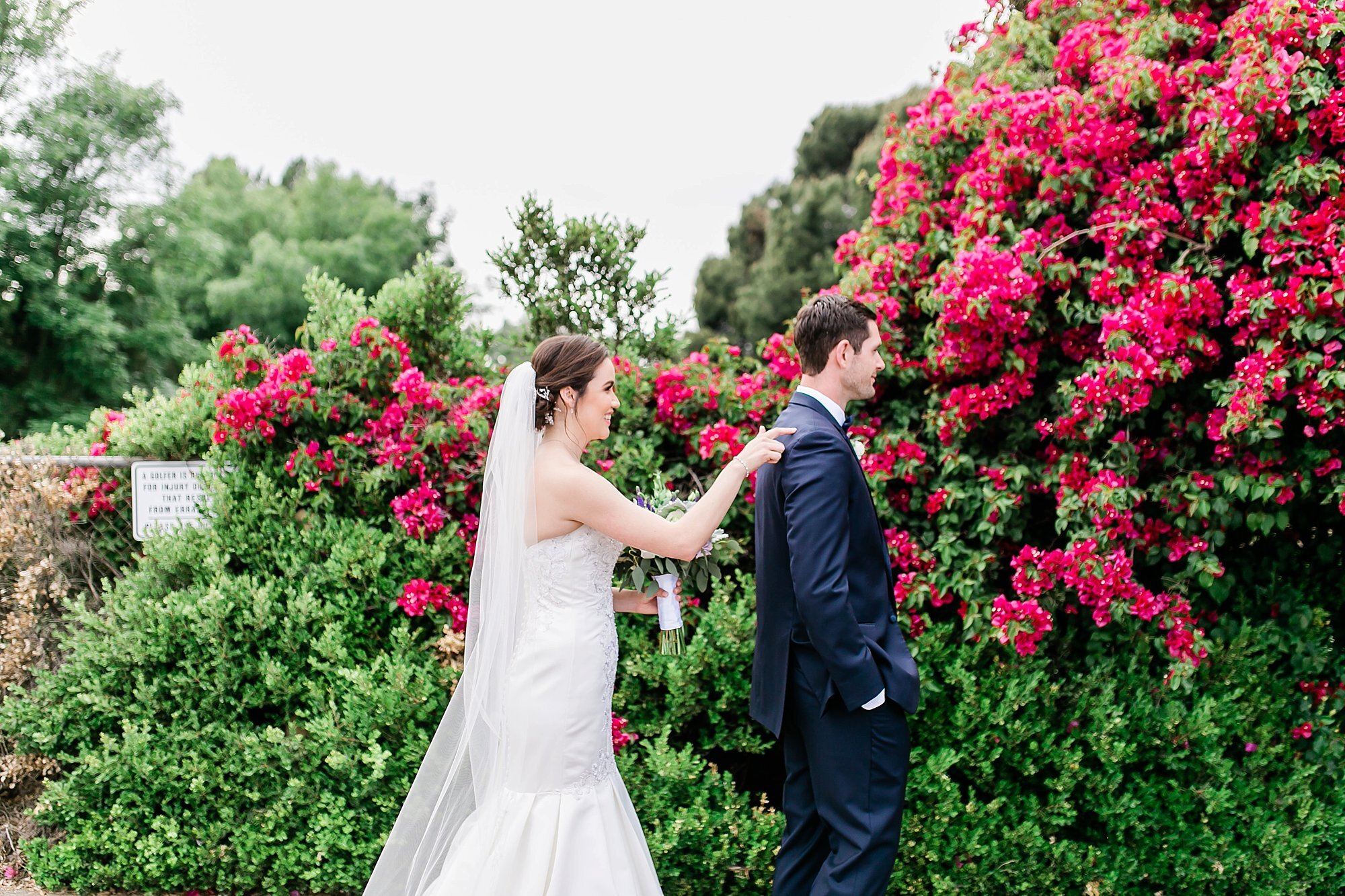  bride and groom in front of the pink flowers 