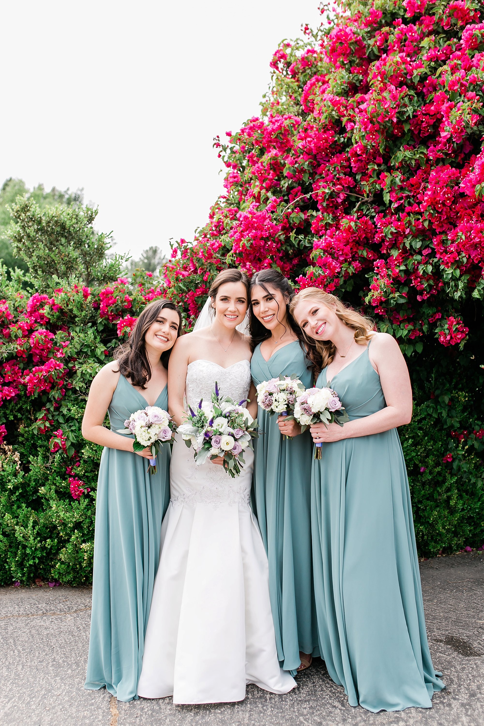  bridal party near the pink flowers 