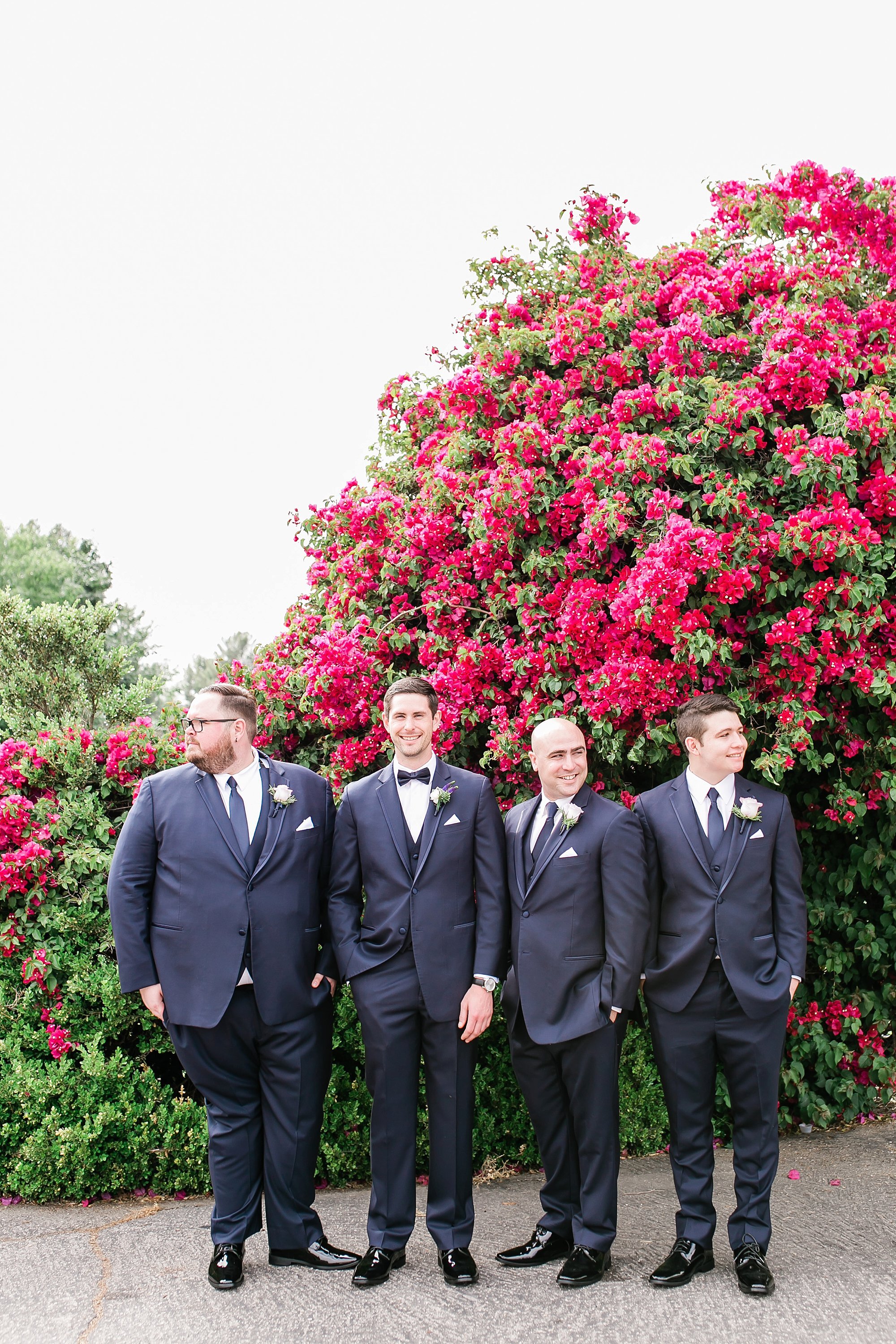  groomsmen near the pink flowers 