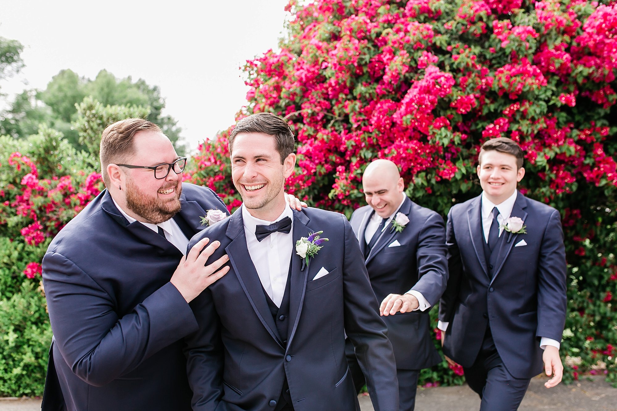  groomsmen near the pink flowers 