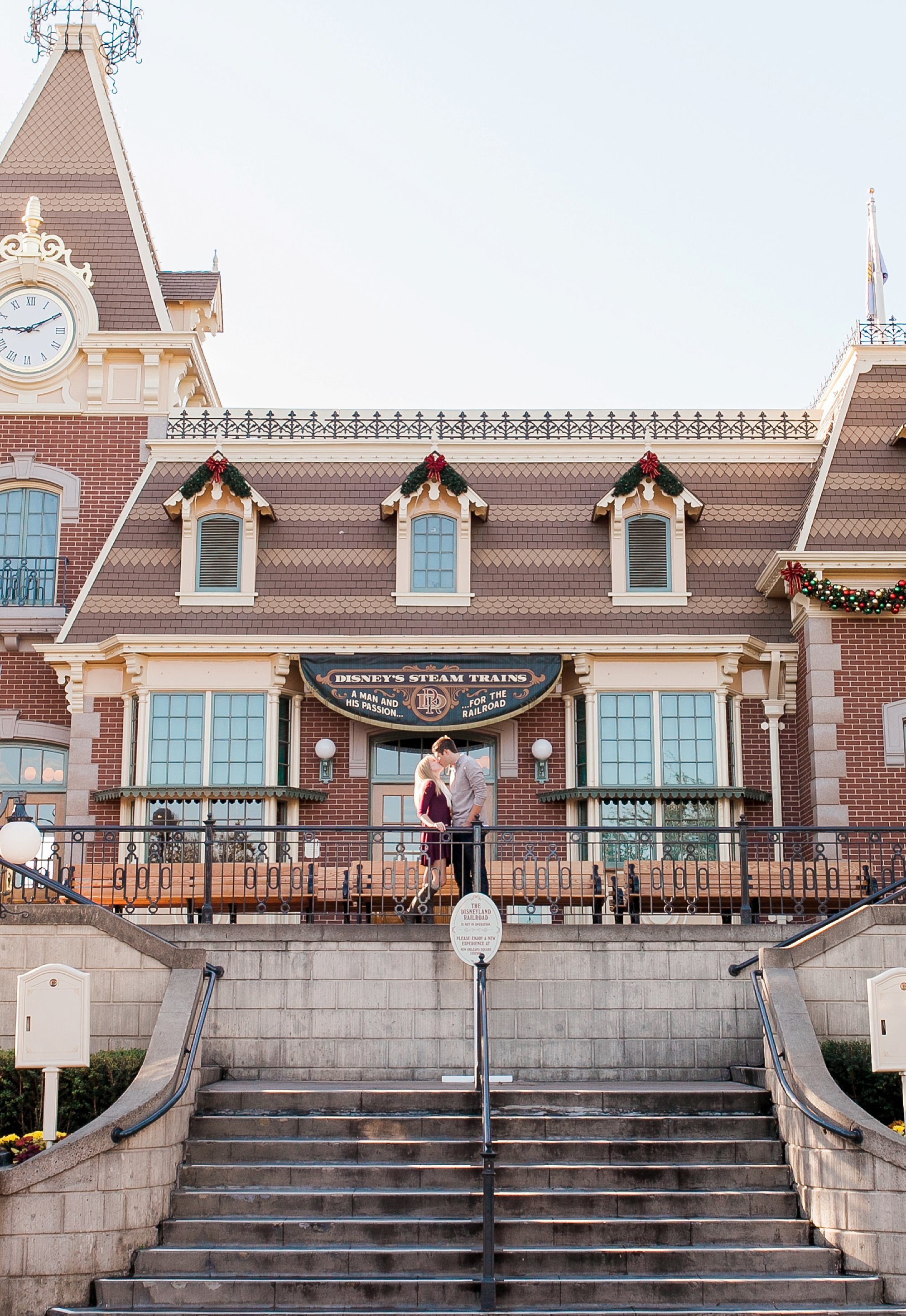  bride and groom looking at one another at the disney train station 