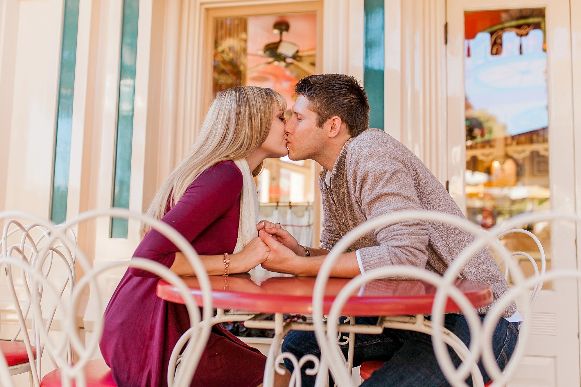  couple kissing in front of an ice cream parlor 