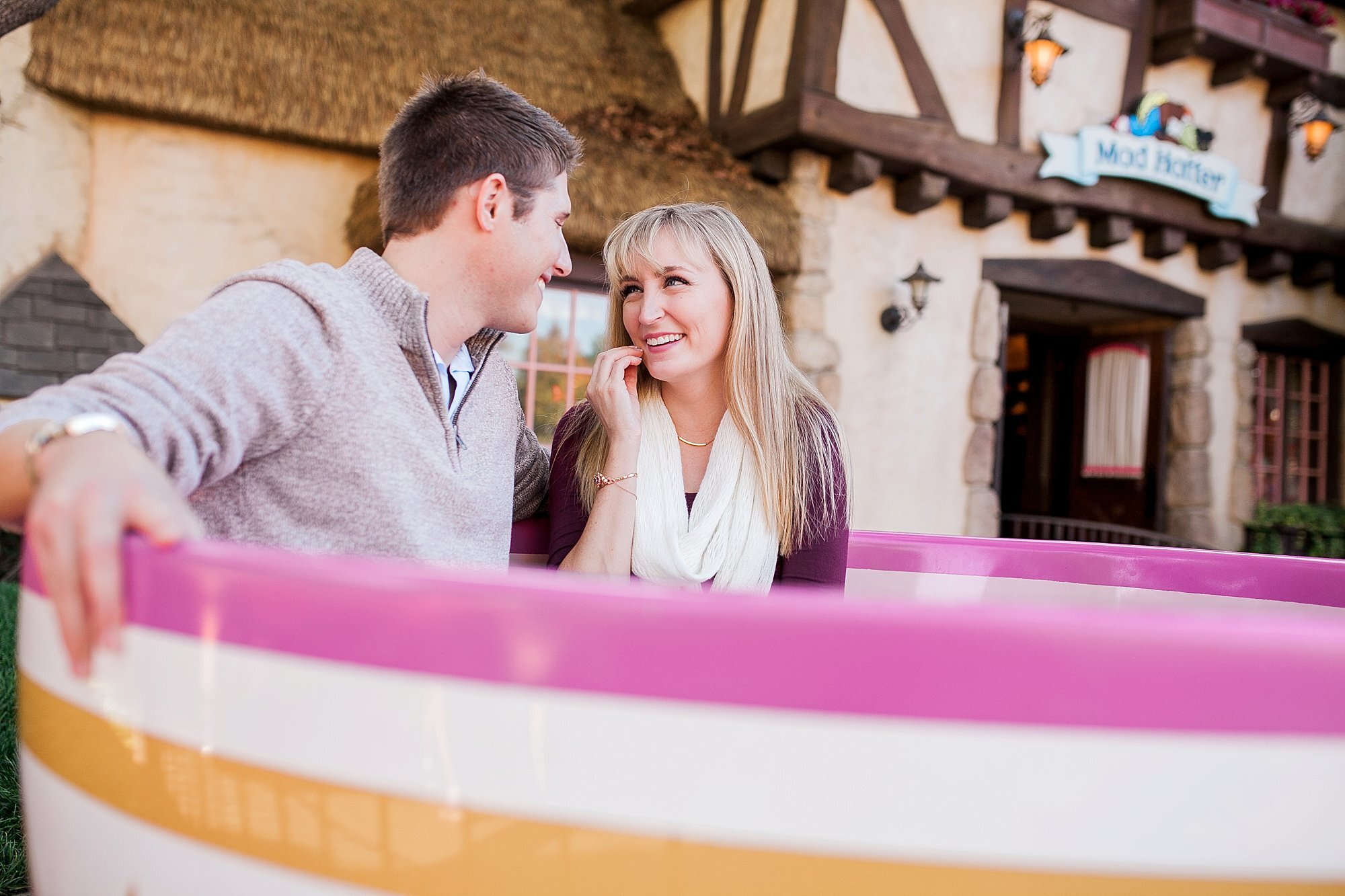  couple sitting in the teacups together 