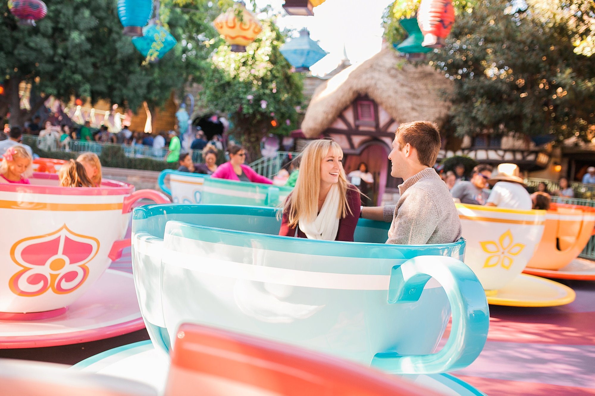  engaged couple riding the teacups together 