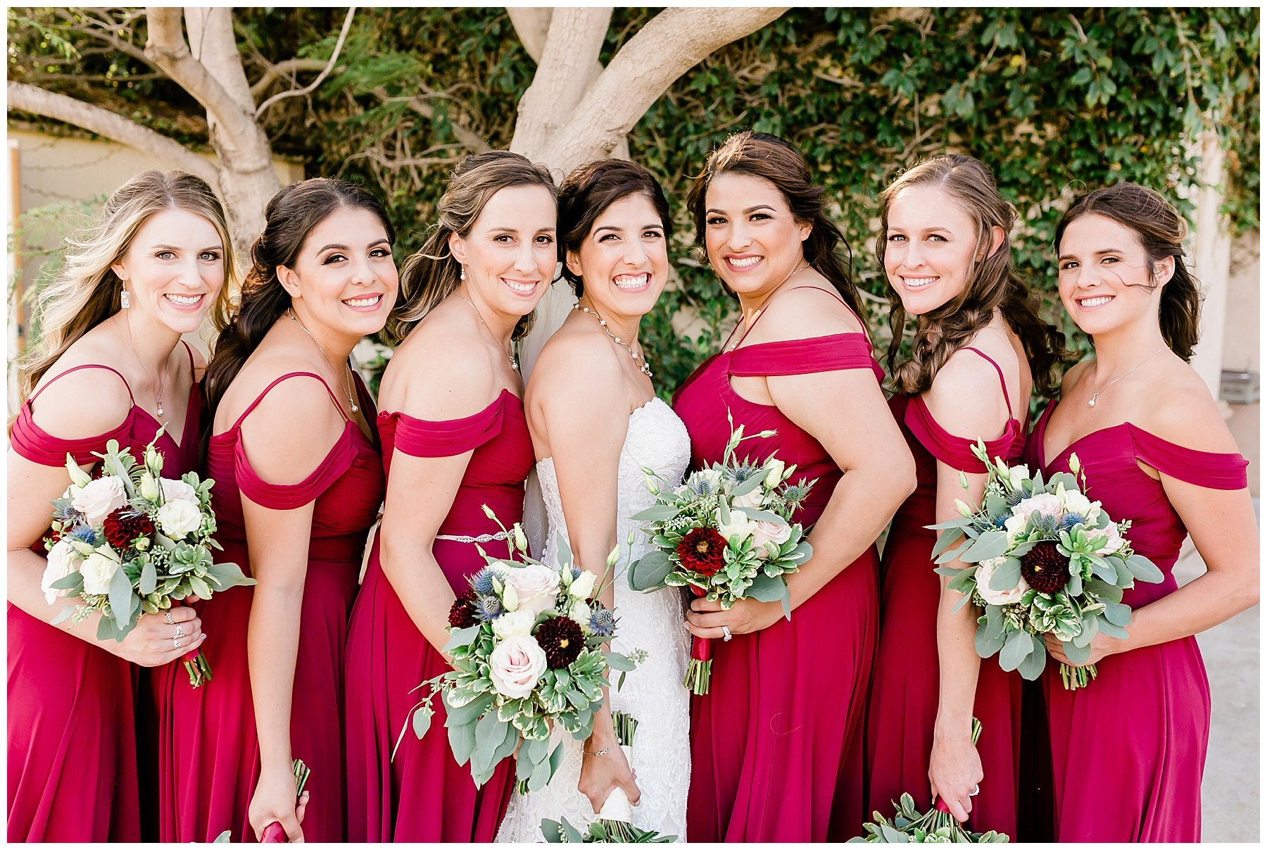  bride in her gown with her bridesmaids 