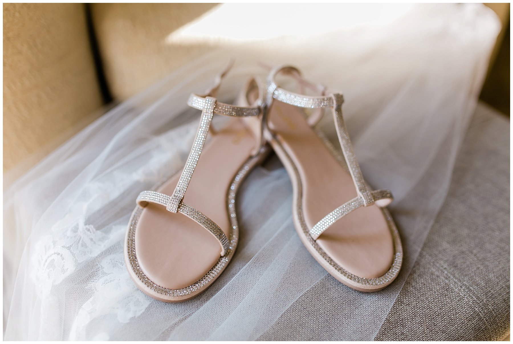  close up of bride’s sandals atop her veil 