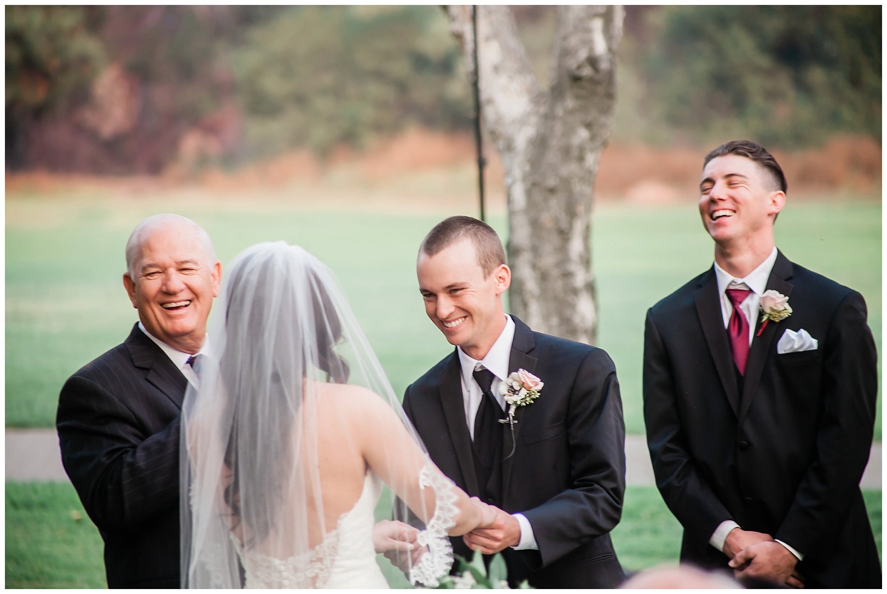  bride and groom holding hands and groom smiling ear to ear 