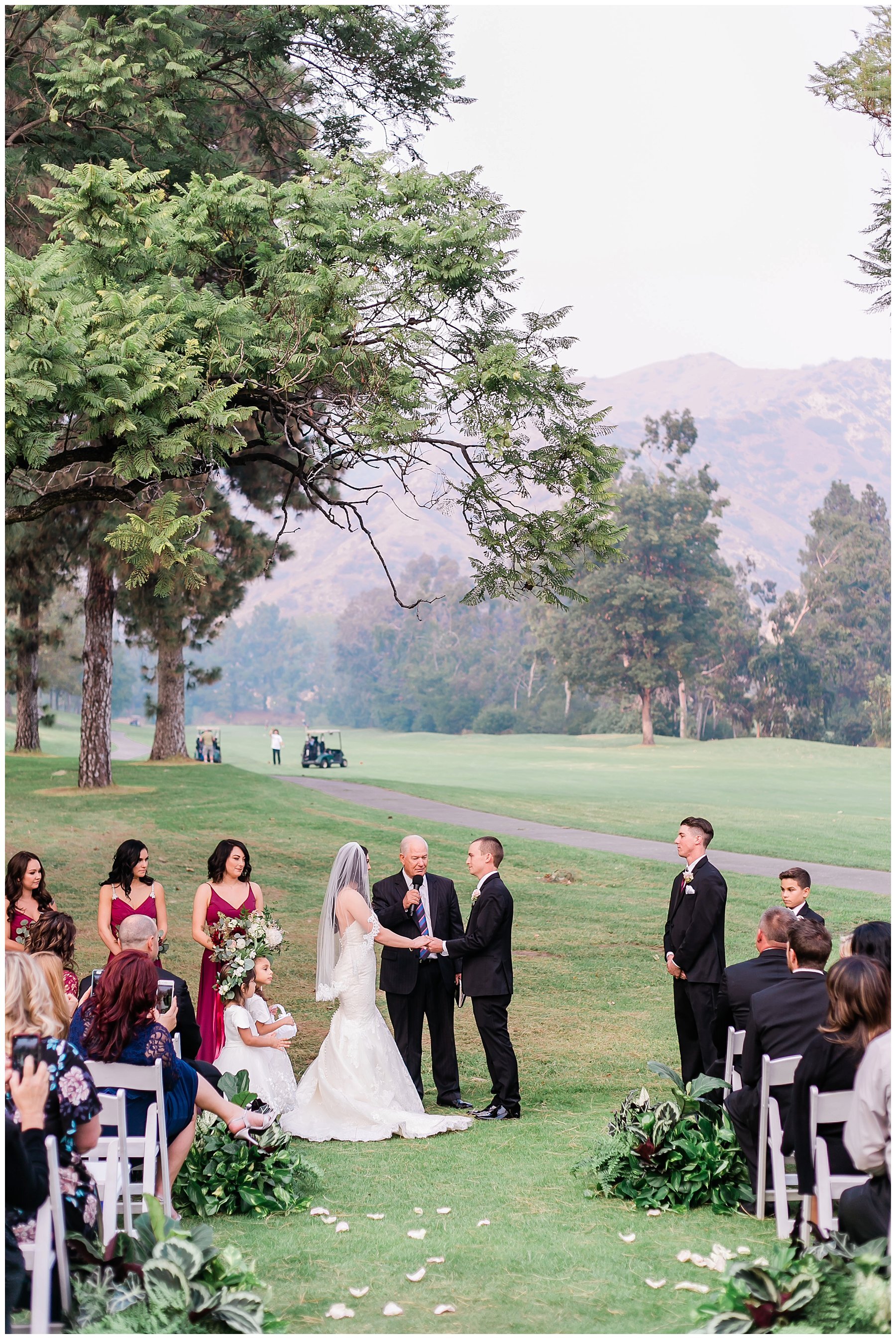  bride and groom holding hands at the altar in front of the golf course 