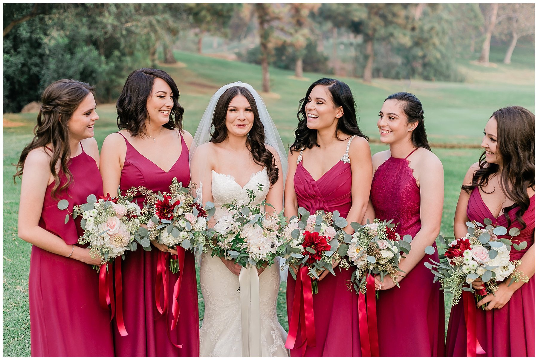  bride and bridesmaids laughing together on the golf course 