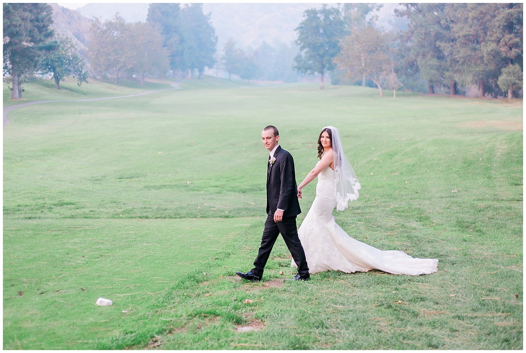  groom leading the bride through the golf course by the hand 