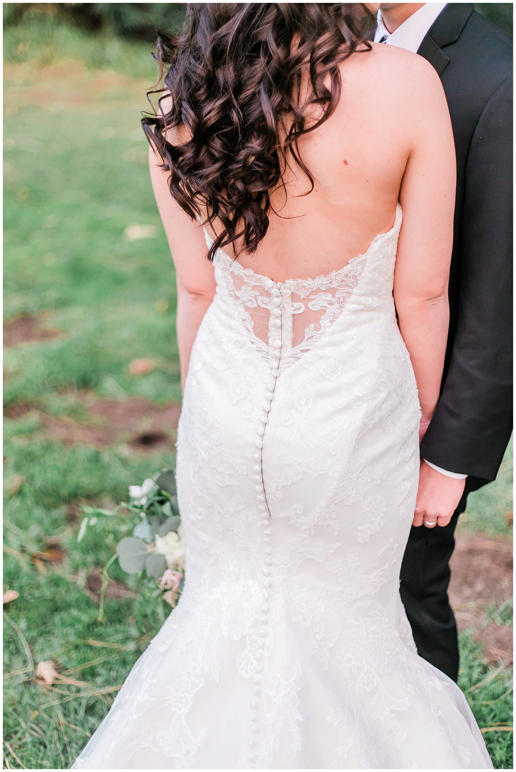 close up of the back of the bride’s dress 
