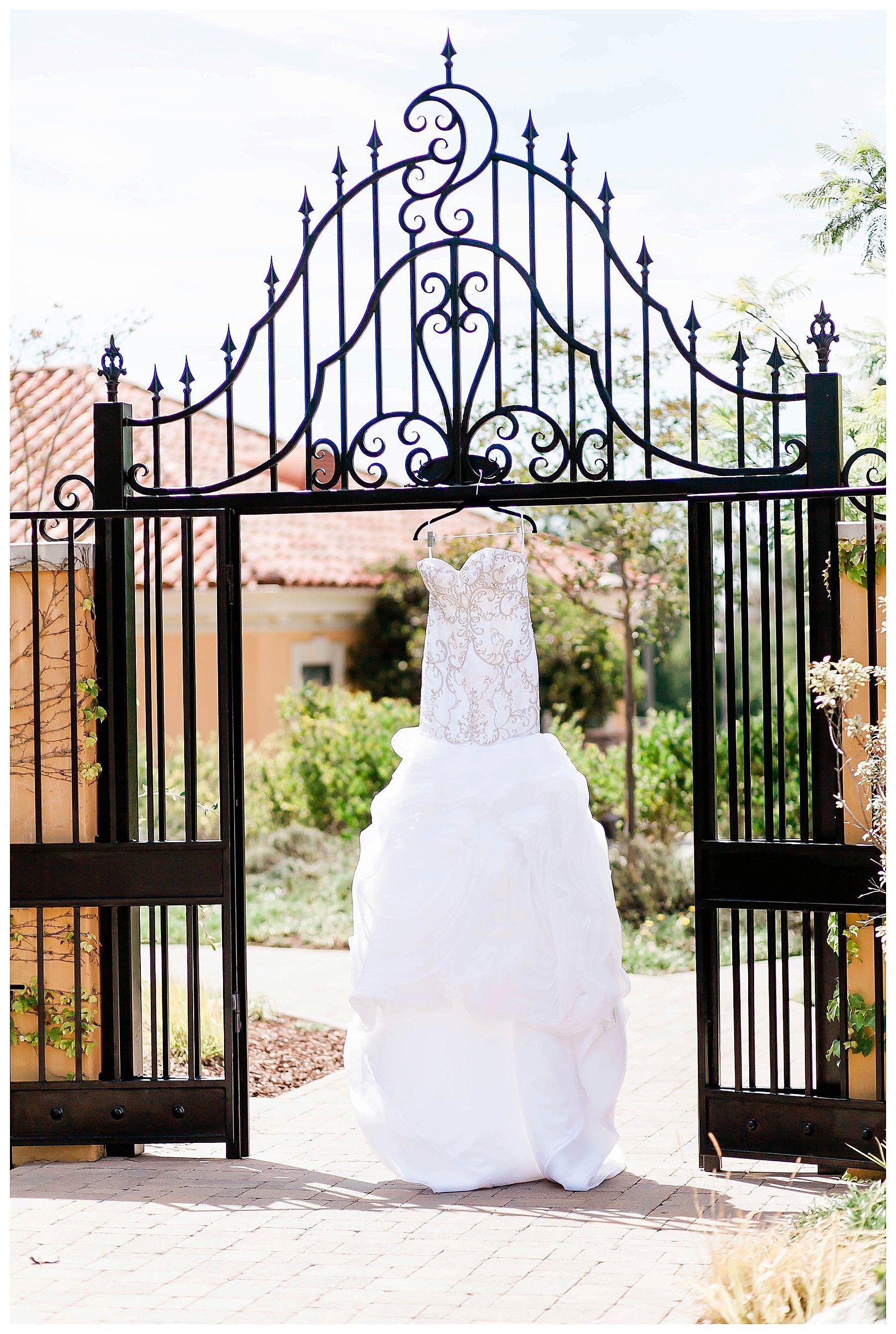  bride’s gown handing on the gate entrance 