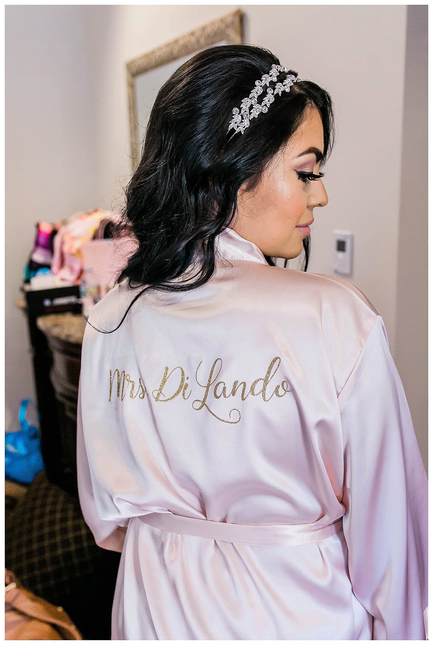  back of bride’s robe says mrs diLando and she is looking over her shoulder  