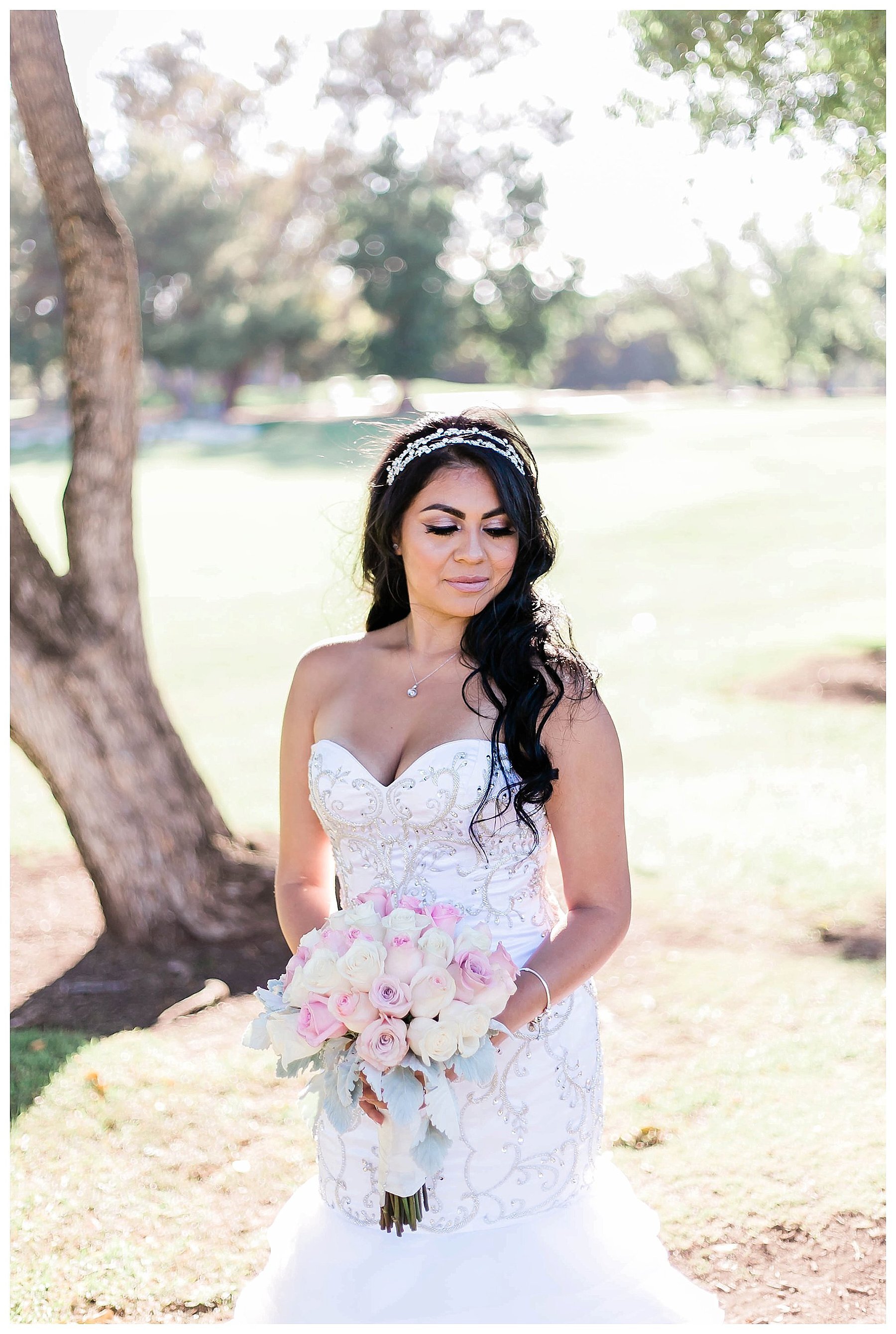  bride looks over her shoulder and holds her bouquet 